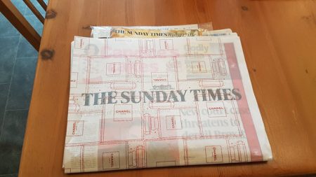 photo of Sunday Times wrapped in advertising cover for Chanel's marketing